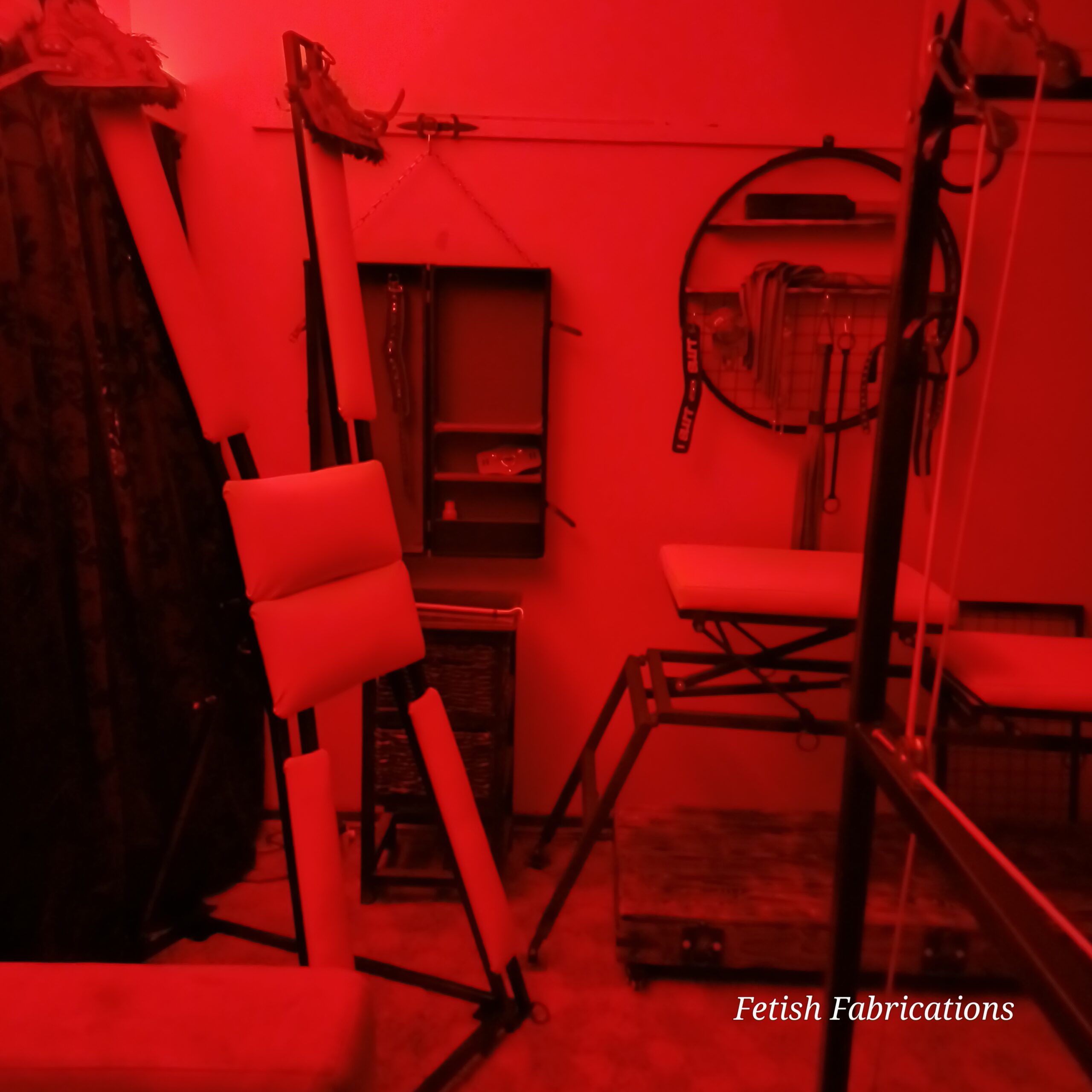 Red private playroom with custom Fetish Fabrications furniture