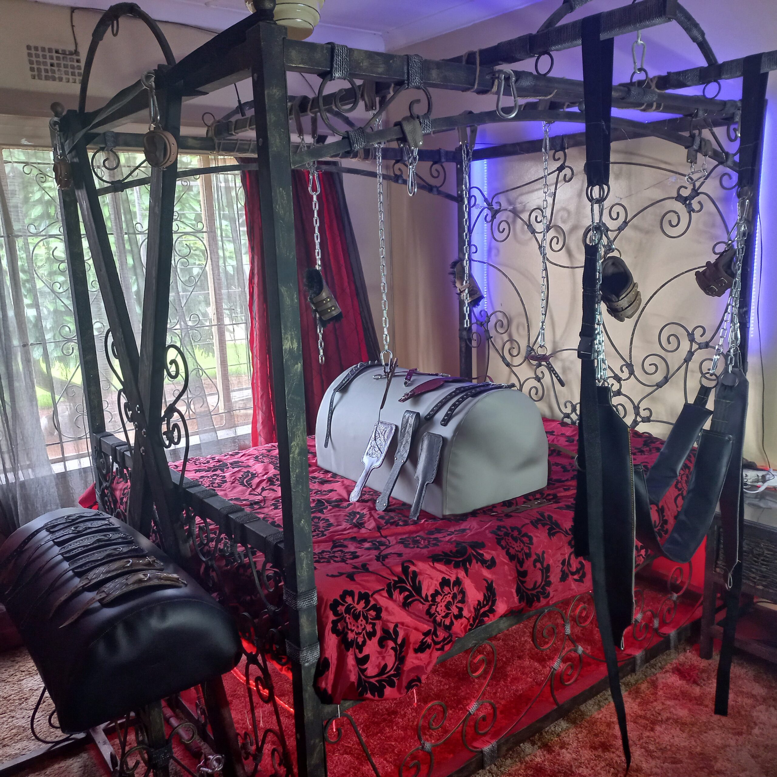 Custom four-poster bondage bed and room setup